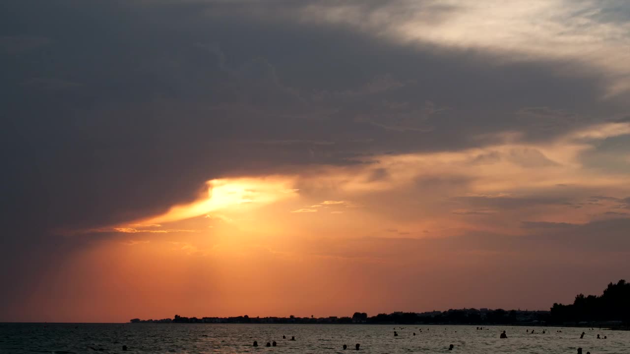Free Video Stock sunset as people swim Live Wallpaper