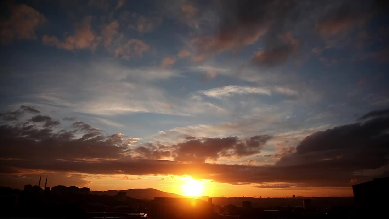 Free Video Stock sunset from a city and clouds traveling in the sky Live Wallpaper
