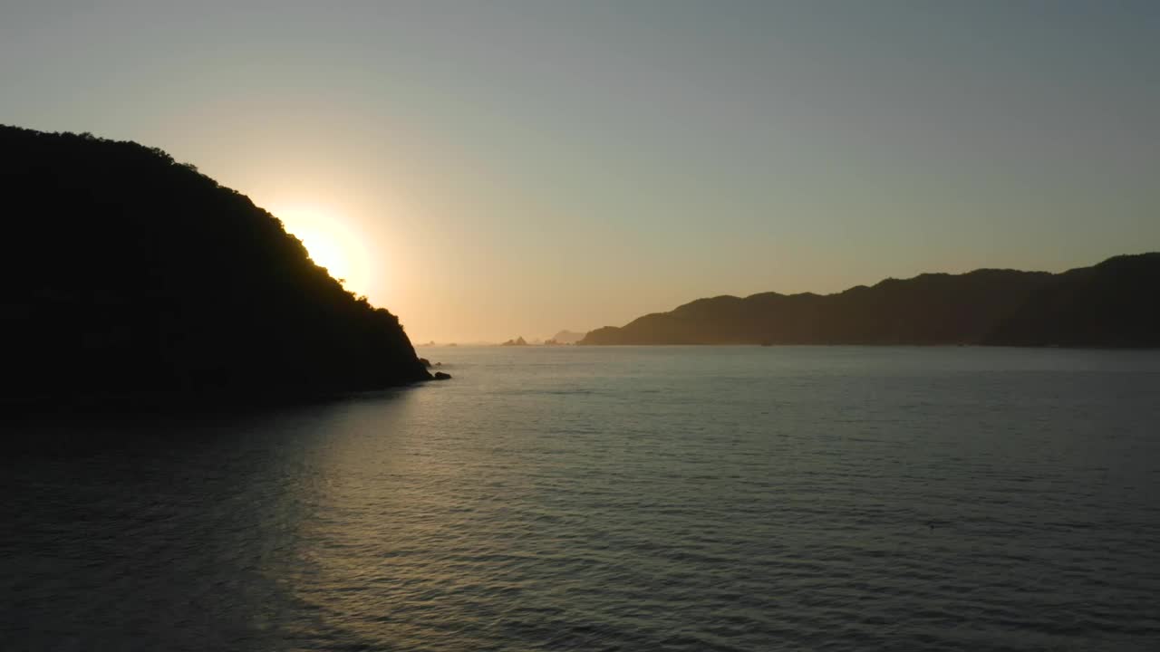 Free Video Stock sunset seen at sea from a coast aerial shot Live Wallpaper