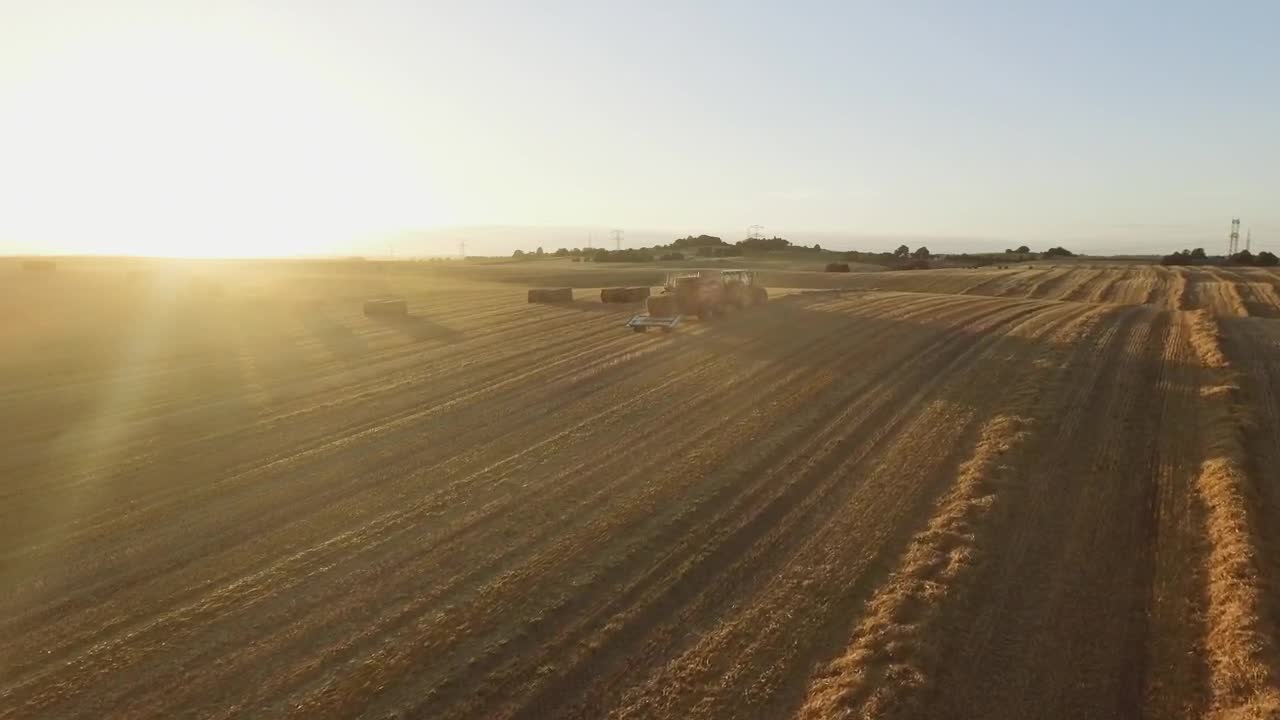 Free Video Stock sunset while a tractor works Live Wallpaper