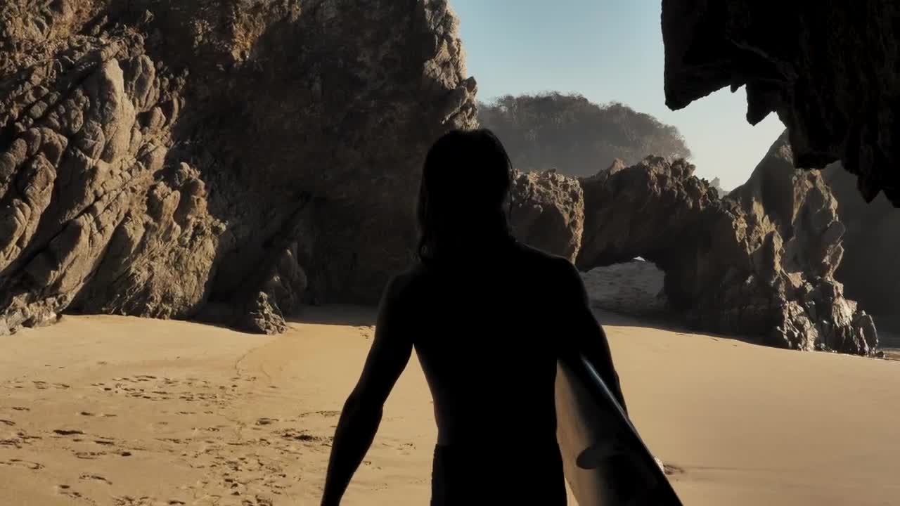 Free Video Stock surfer walking on the beach holding his board Live Wallpaper