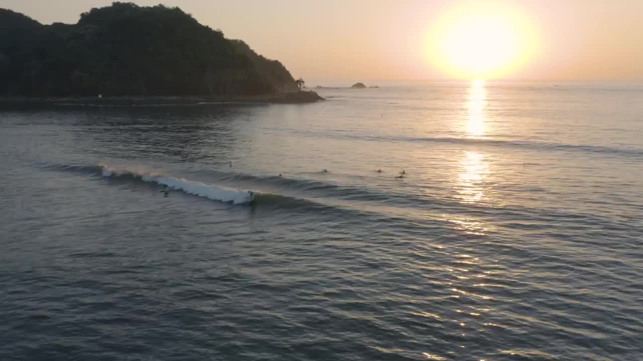 Free Video Stock surfers on waves of a beach from above Live Wallpaper