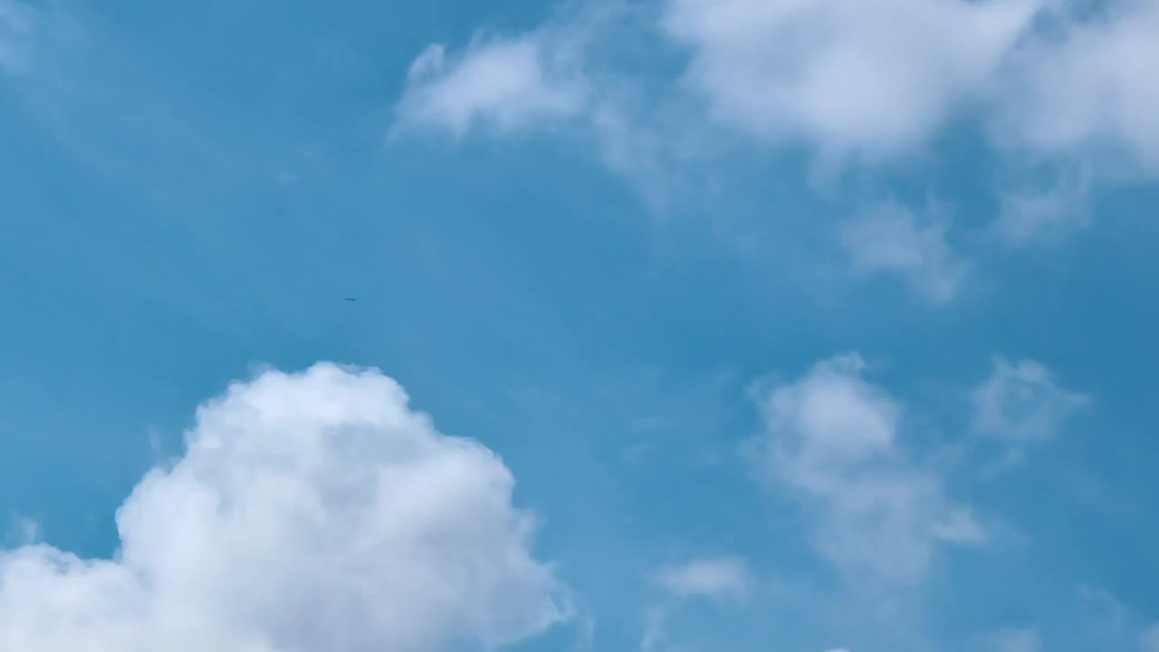 Free Video Stock swirling clouds above a light blue sky Live Wallpaper
