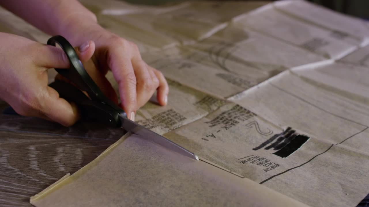 Free Video Stock tailor cutting out a design with scissors Live Wallpaper