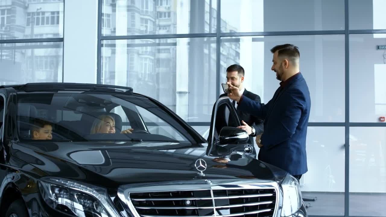 Free Video Stock taking a picture of the new car in the dealership Live Wallpaper