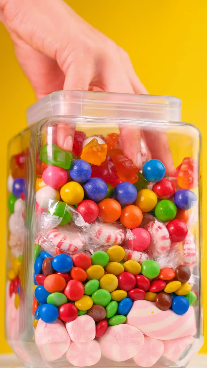 Free Video Stock taking candy from a pot that is on a yellow Live Wallpaper