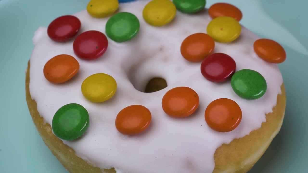 Free Video Stock taking glazed donut with colored chocolates from a plate Live Wallpaper
