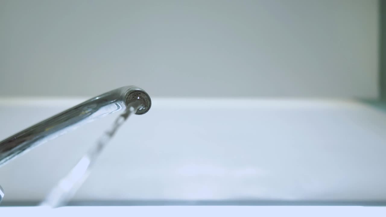 Free Video Stock tap turns on to pour water seen from below Live Wallpaper