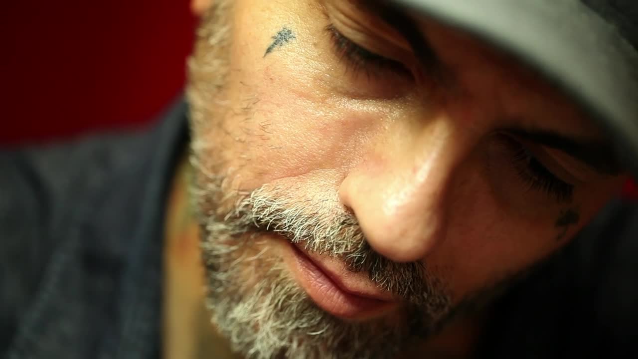 Free Video Stock tattoo artist doing a tattoo to a client Live Wallpaper