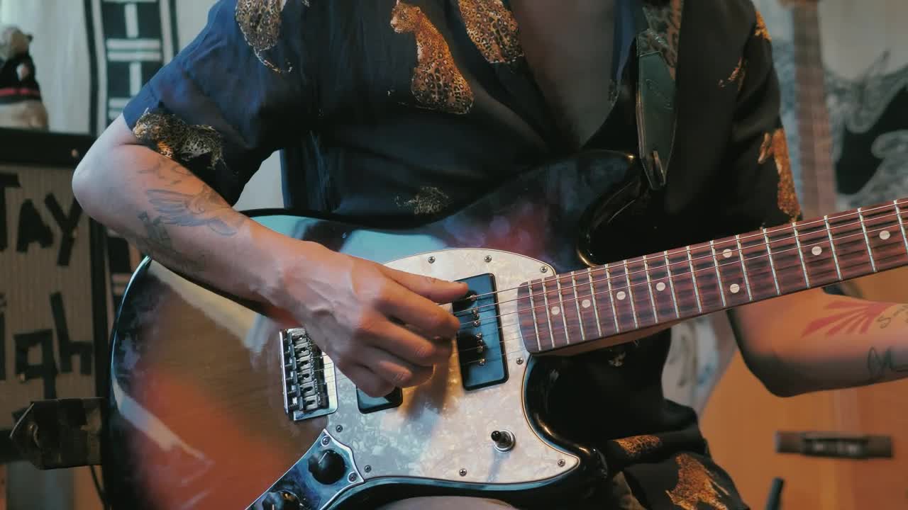 Free Video Stock tattooed man playing an electric guitar Live Wallpaper