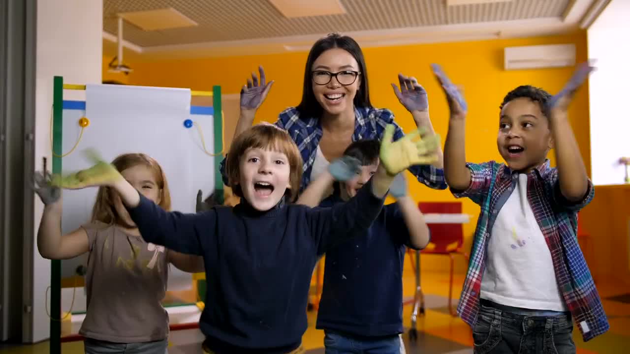 Free Video Stock teacher and students waving with painted hands Live Wallpaper