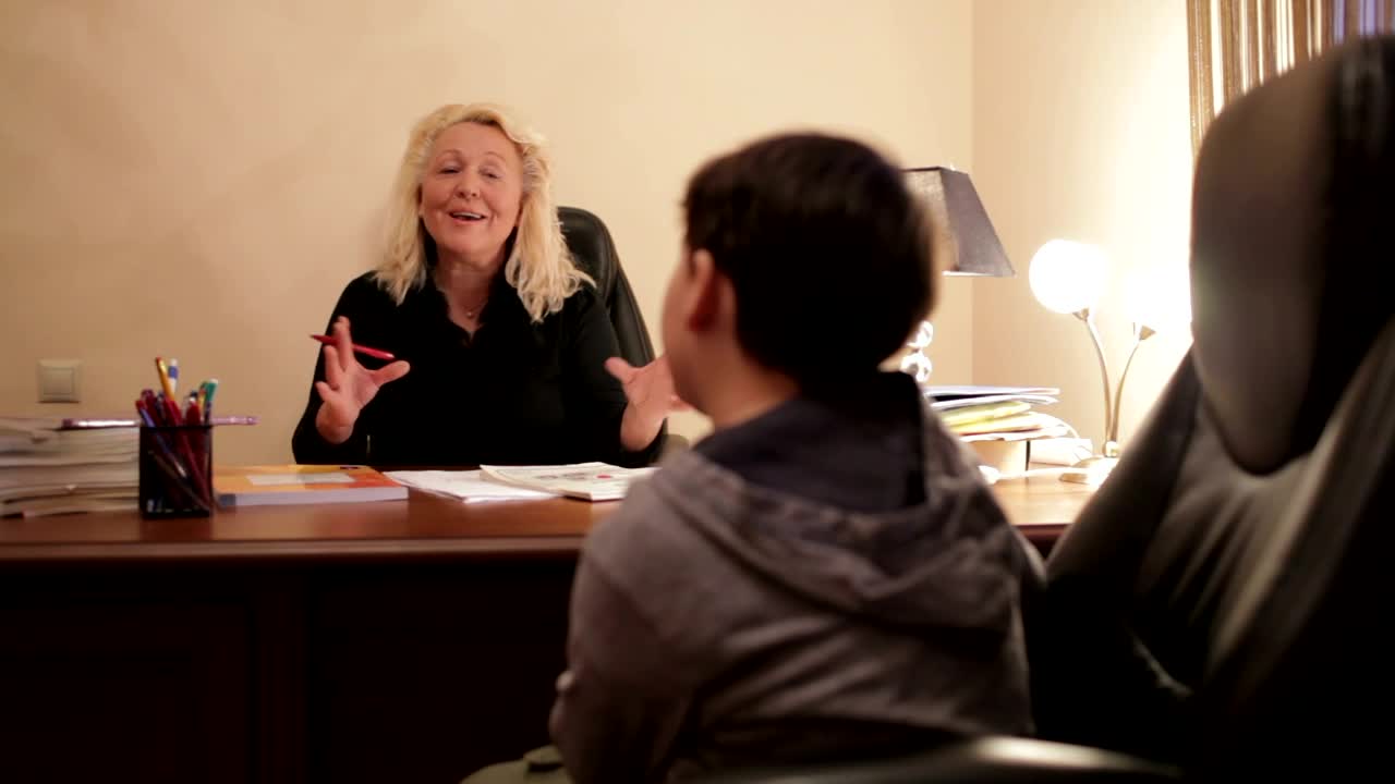 Free Video Stock teacher speaking to a young student Live Wallpaper