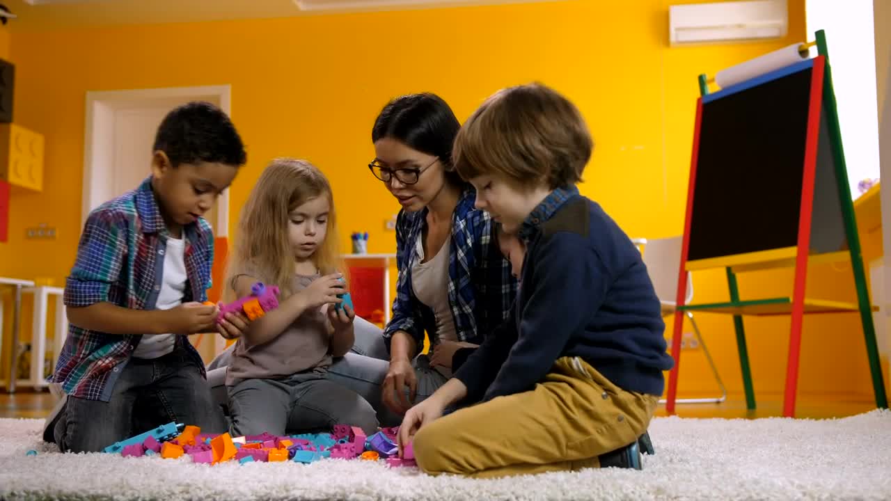 Free Video Stock teacher with little children playing with legos Live Wallpaper