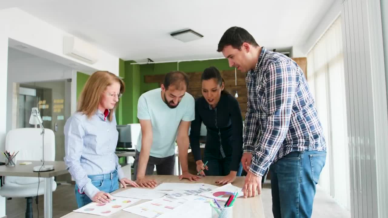 Free Video Stock team collaborates on idea in casual office Live Wallpaper