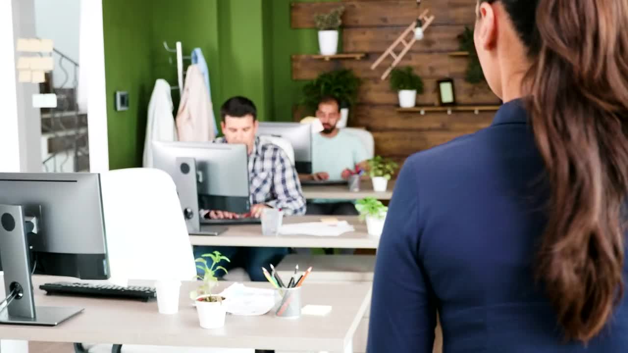 Free Video Stock team leader chats with man in creative office Live Wallpaper