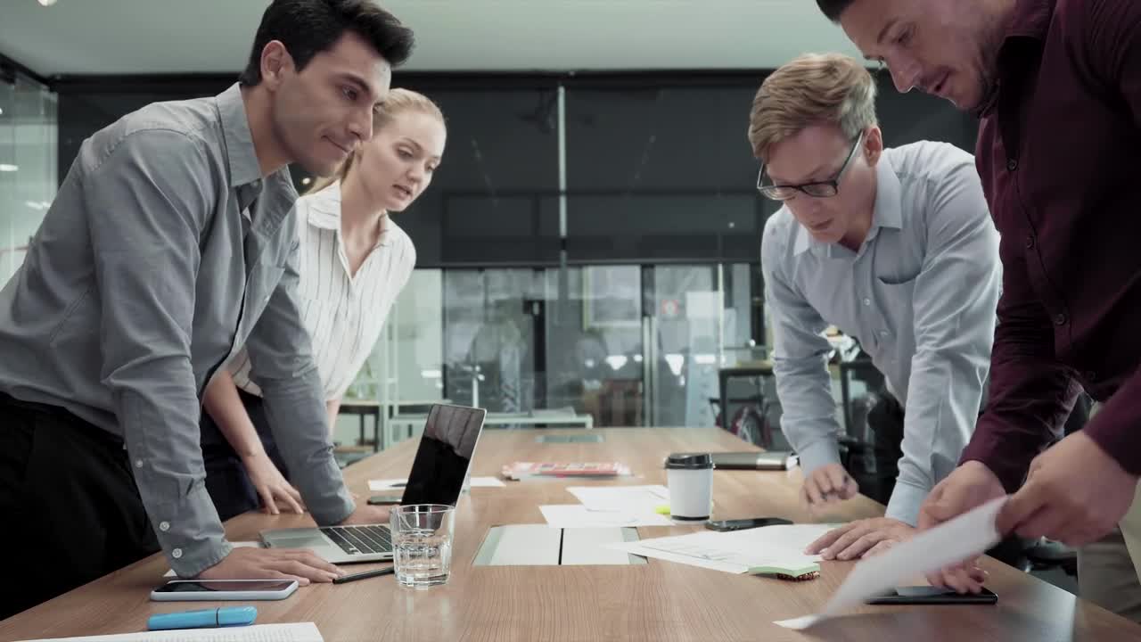 Free Video Stock team standing around a table Live Wallpaper