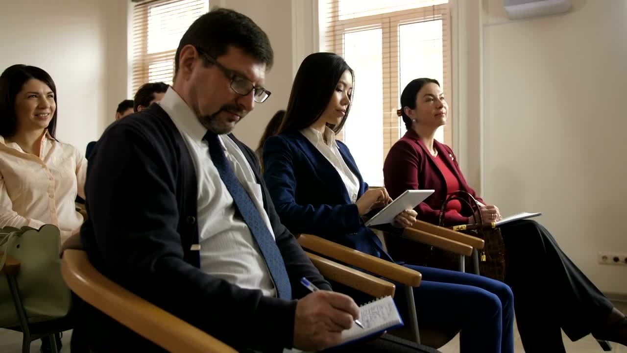 Free Video Stock team writing notes during a speech Live Wallpaper