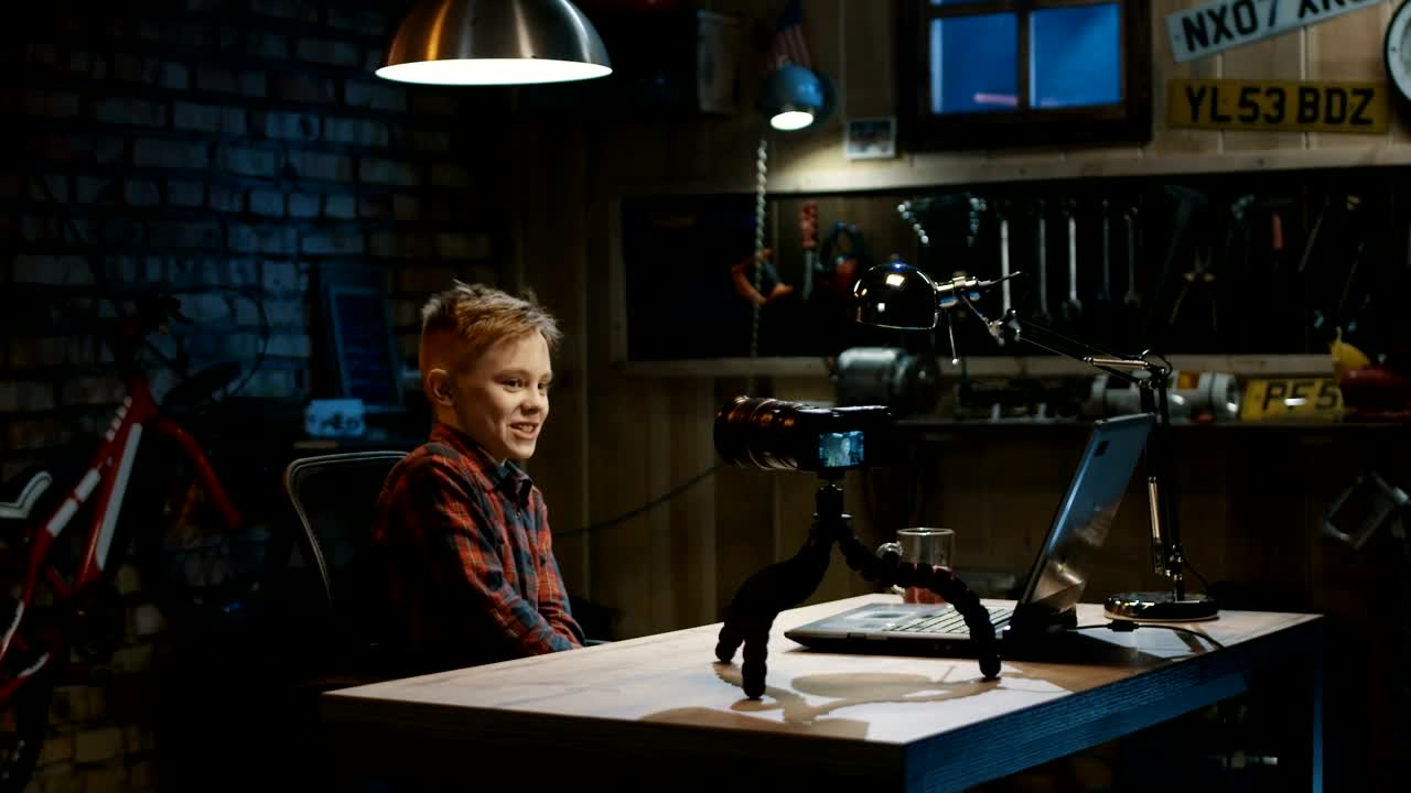 Free Video Stock teen boy doing a video blog in the garage Live Wallpaper