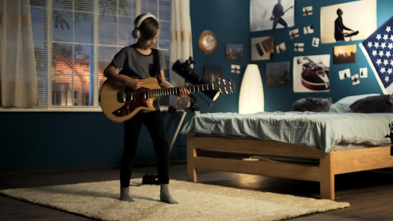 Free Video Stock teen boy playing the guitar on the bedroom Live Wallpaper
