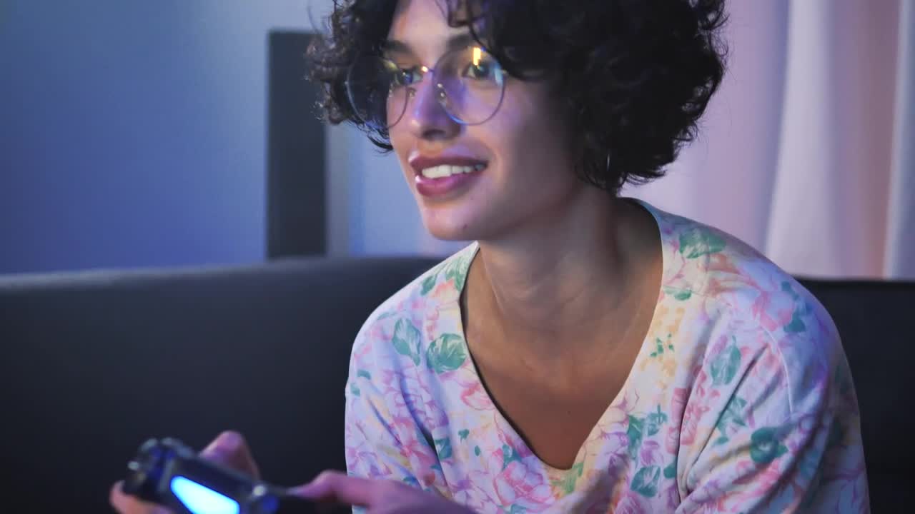 Free Video Stock teen with glasses playing video games on the sofa Live Wallpaper