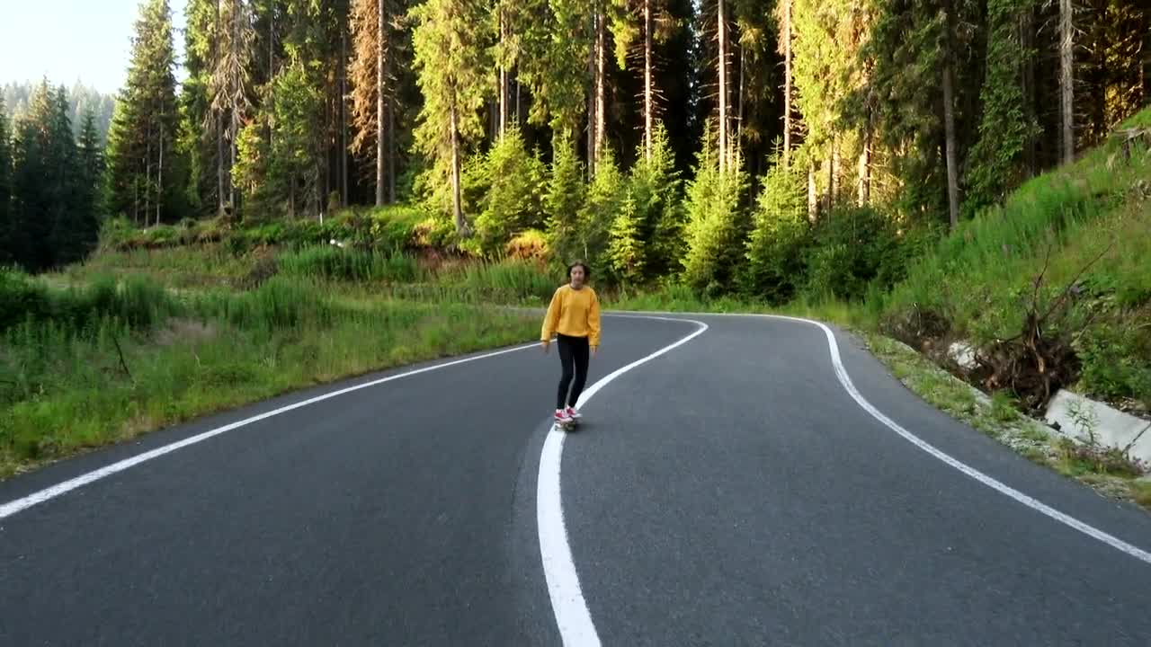Free Video Stock teen woman on a skateboard on the road Live Wallpaper