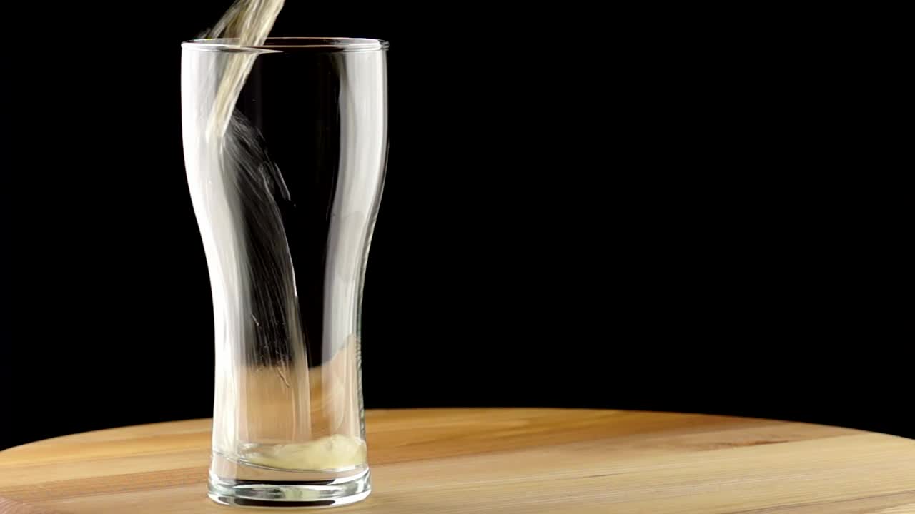 Free Video Stock the beer poured into a glass on a table Live Wallpaper