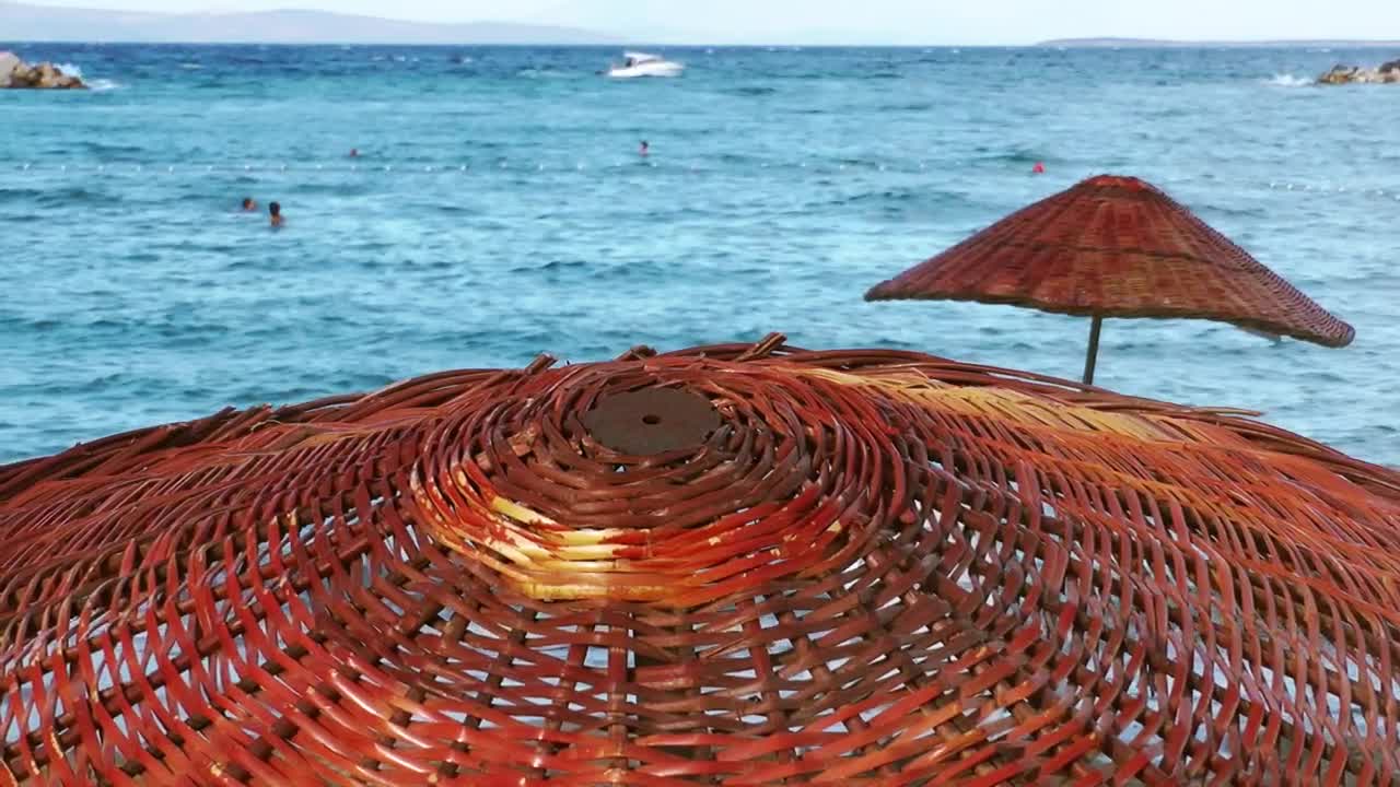 Free Video Stock the sea seen from above a wooden umbrella Live Wallpaper