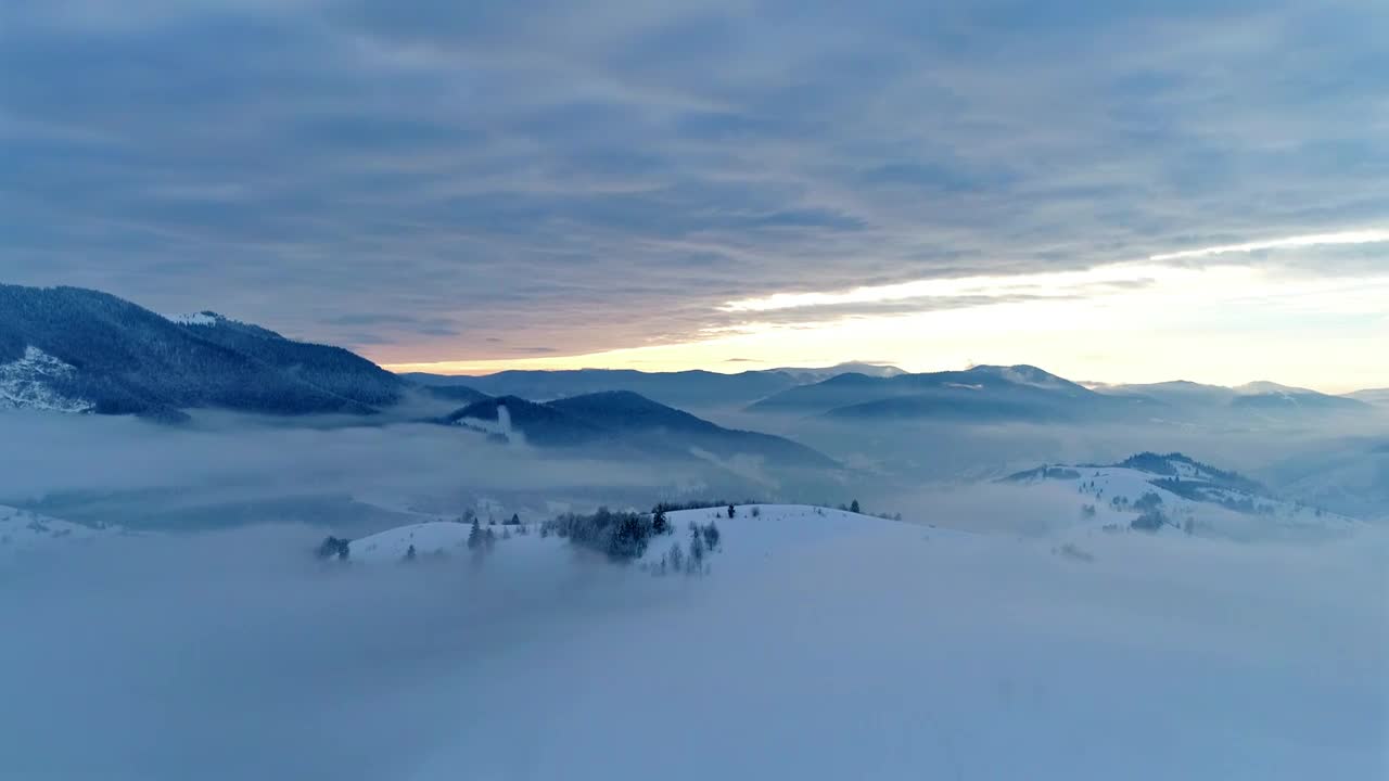 Free Video Stock thick layer of clouds over snowy mountains Live Wallpaper