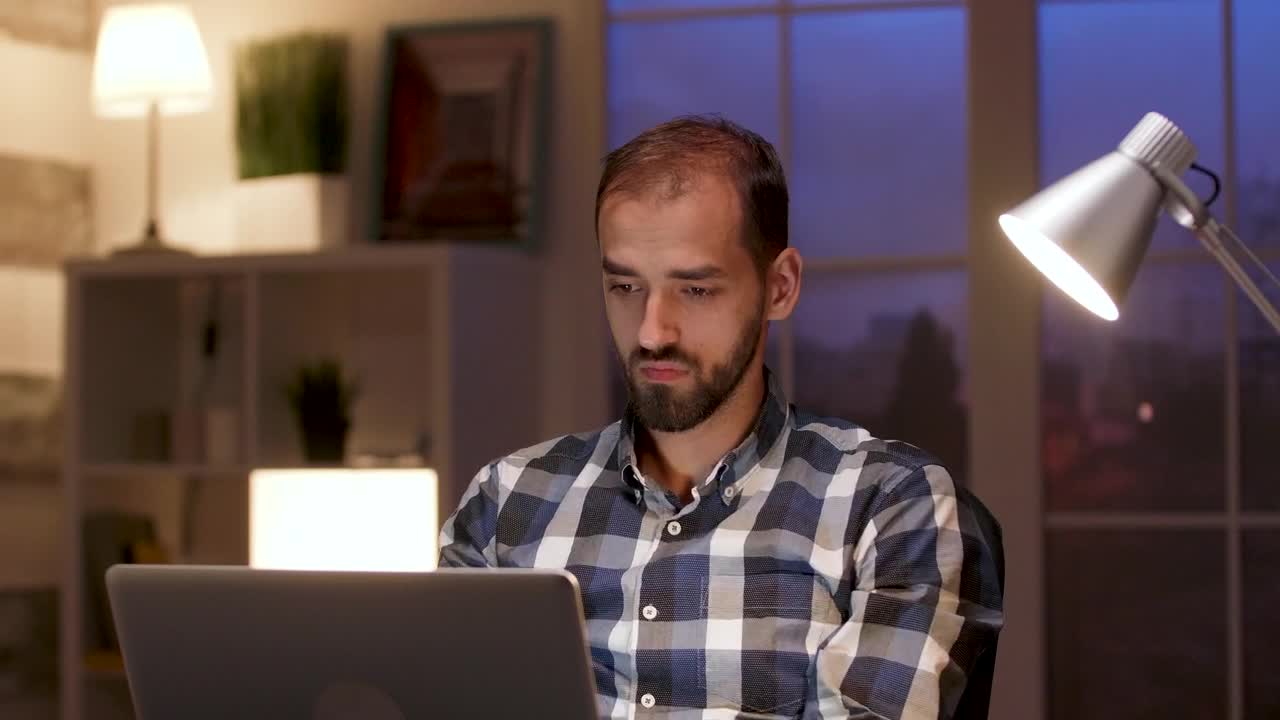 Free Video Stock thinking man works late and stretches in home office Live Wallpaper