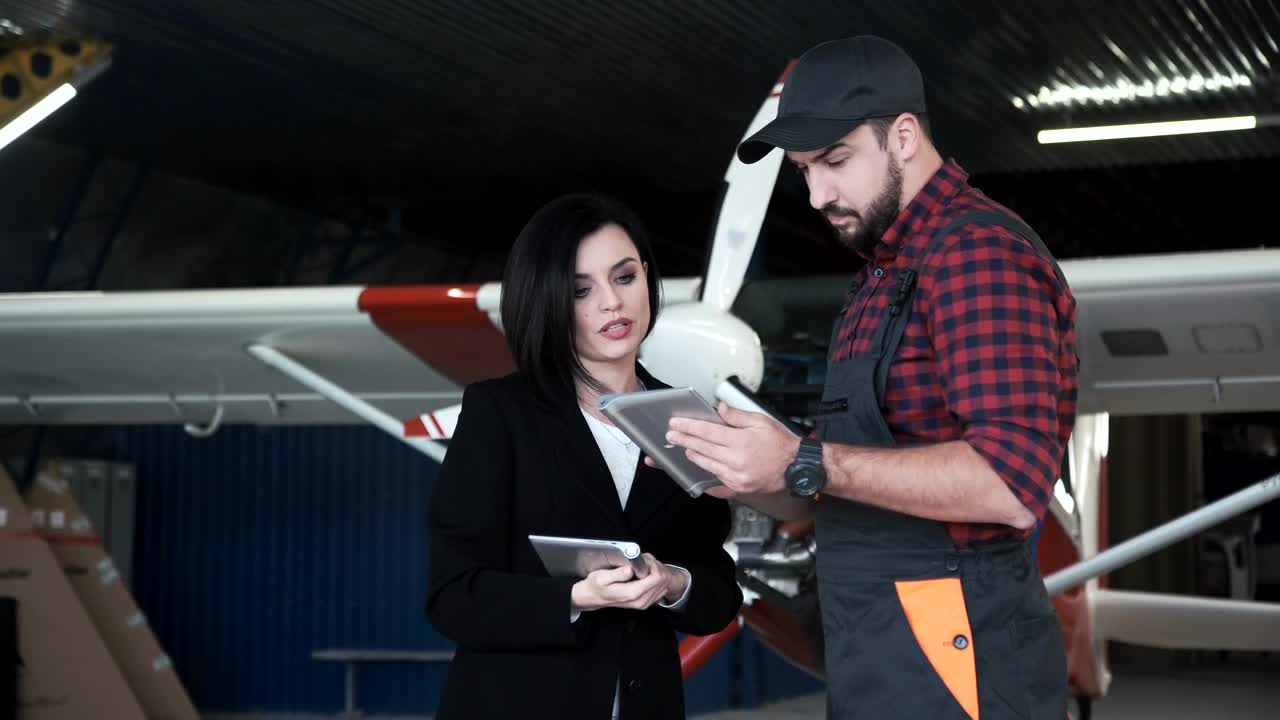 Free Video Stock this woman talking to plane technician Live Wallpaper