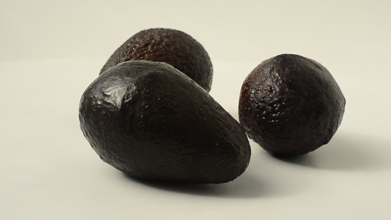 Free Video Stock three avocados rotating on a white background Live Wallpaper