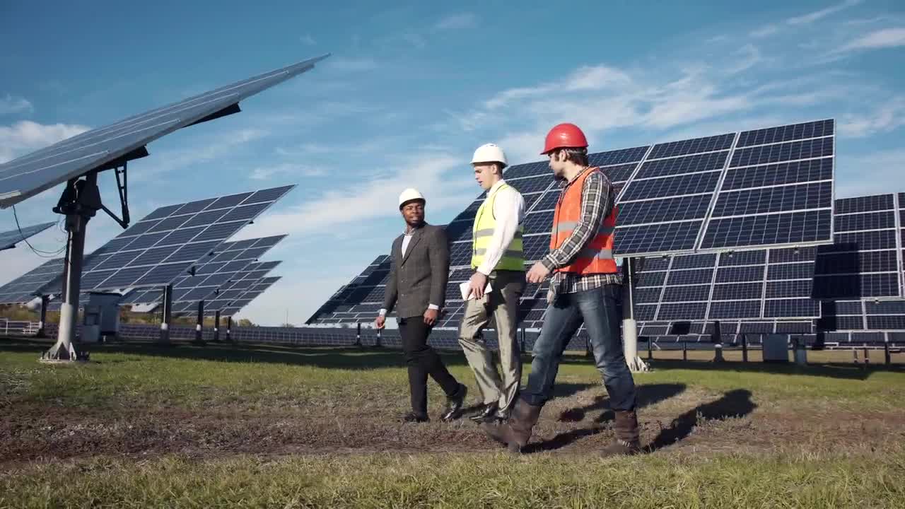 Free Video Stock three engineers working on a solar panel field Live Wallpaper