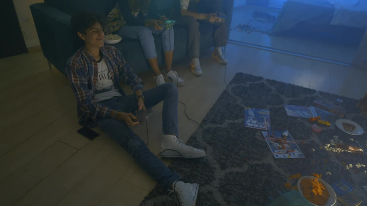 Free Video Stock three friends during a video games night Live Wallpaper