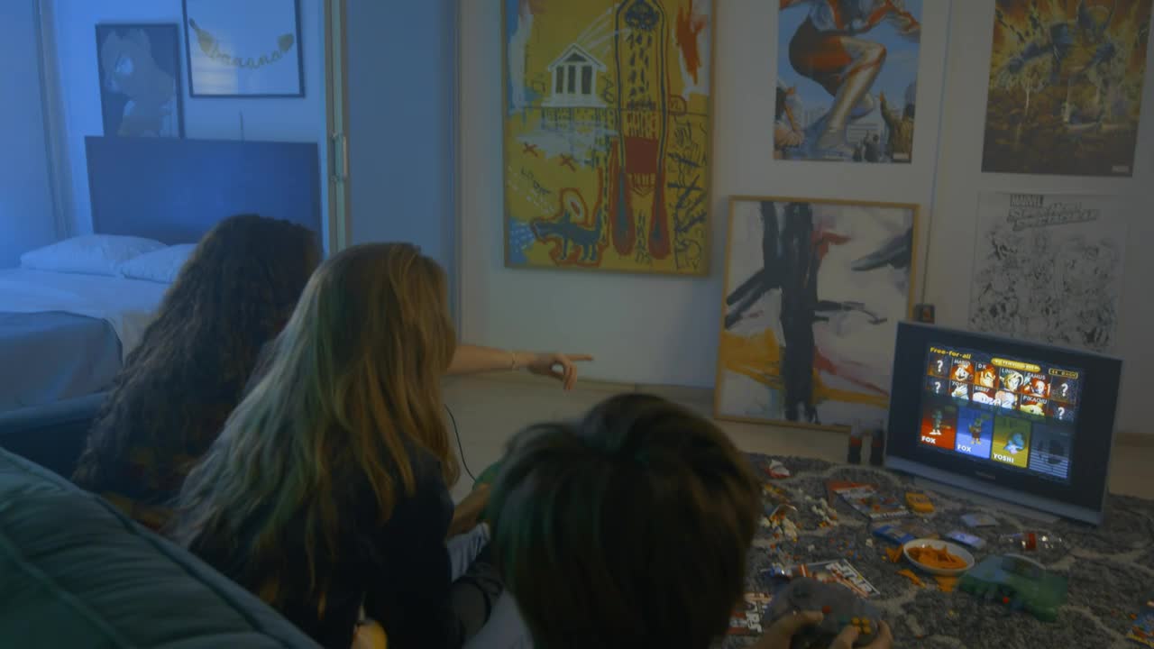 Free Video Stock three friends playing video games with snacks Live Wallpaper