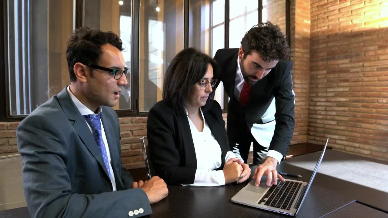 Free Video Stock three office colleagues working together Live Wallpaper