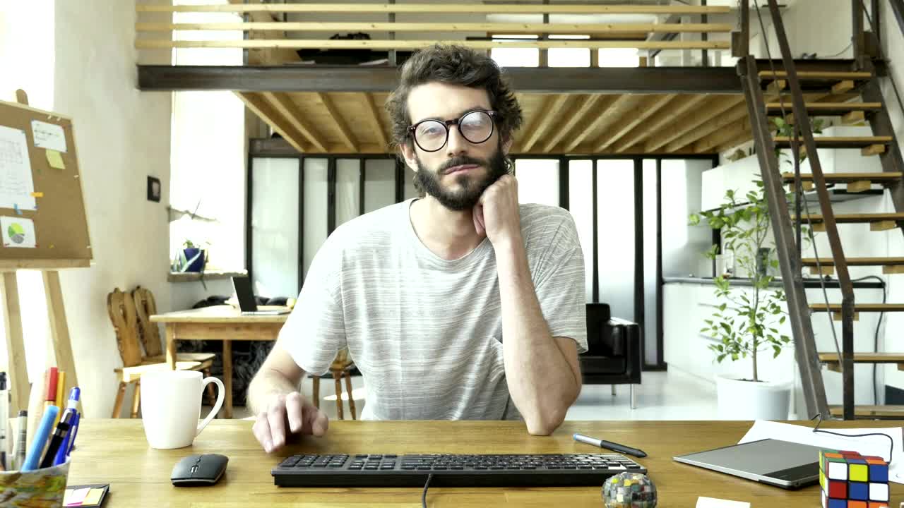Free Video Stock tired and bored man in front of a computer Live Wallpaper