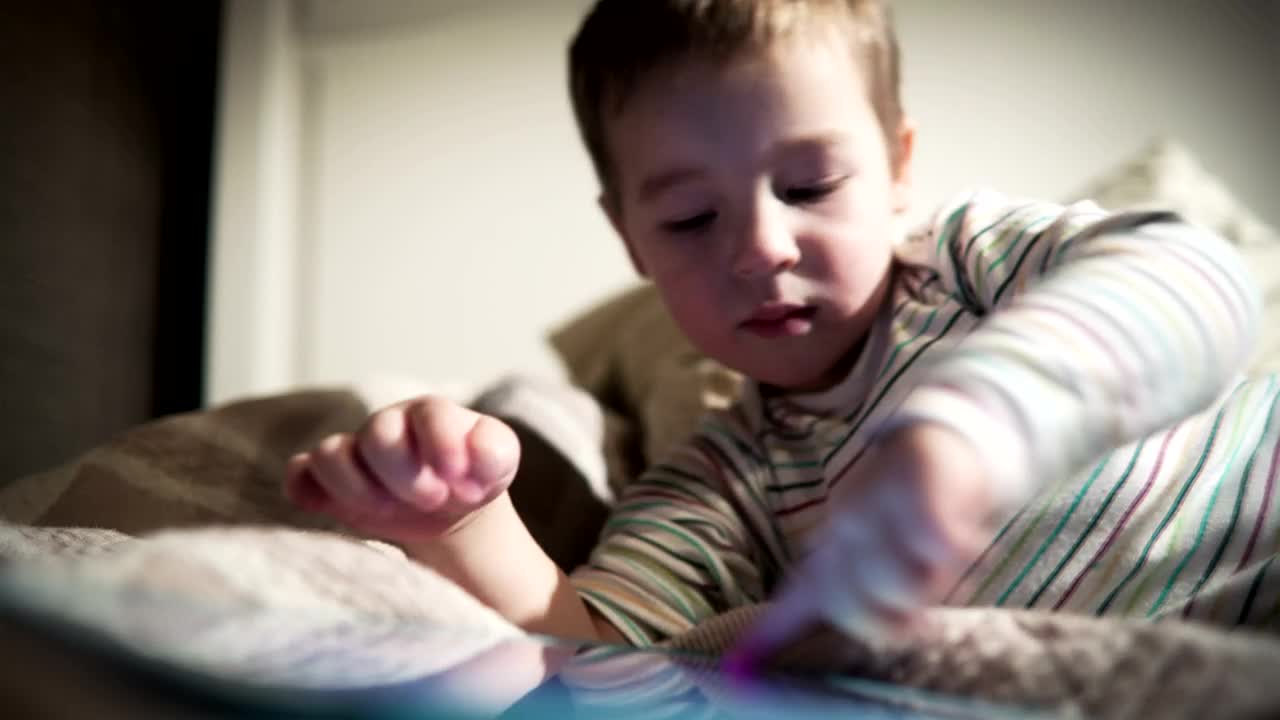 Free Video Stock tired boy using a tablet Live Wallpaper