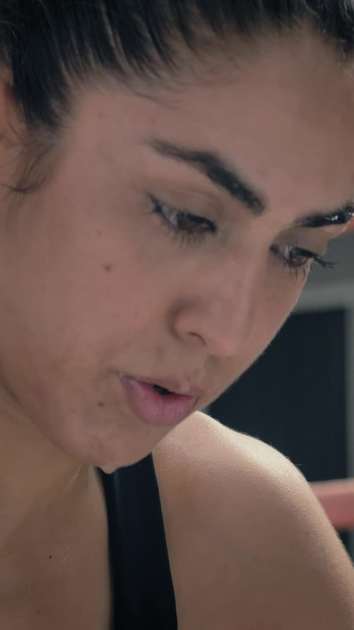 Free Video Stock tired female kickboxer resting after workout Live Wallpaper