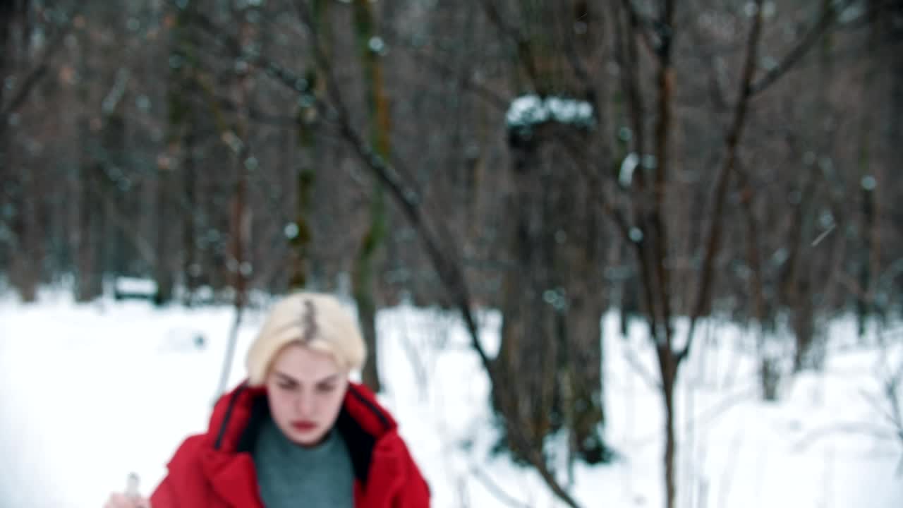 Free Video Stock tired female skier walks in the snow in the forest Live Wallpaper
