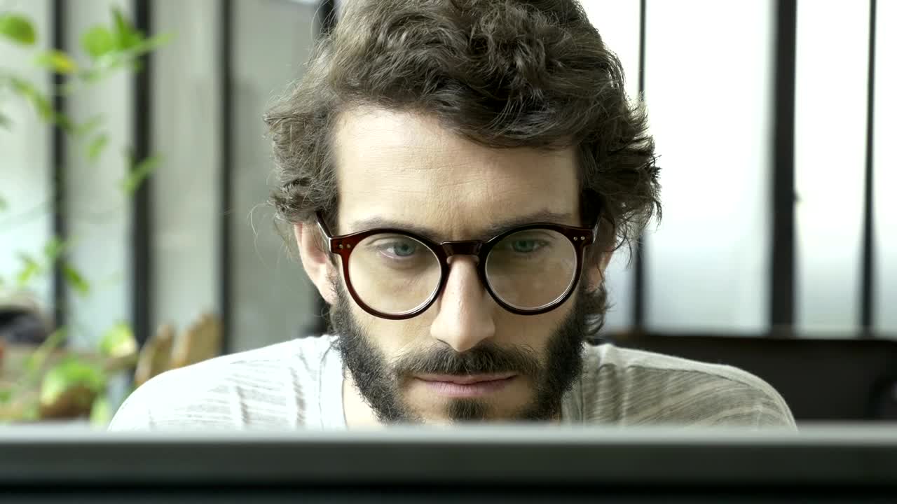 Free Video Stock tired man reading at the computer rest his eyes Live Wallpaper