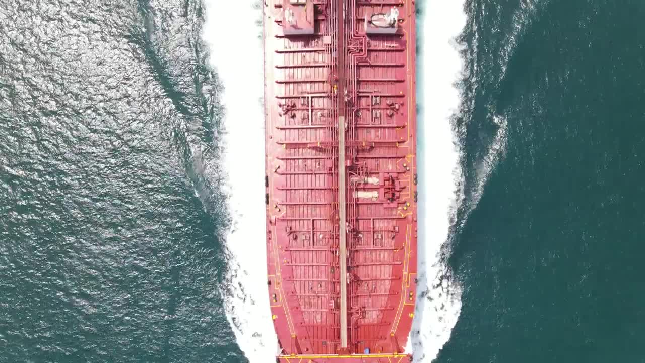 Free Video Stock top aerial shot of a cargo ship sailing in sea Live Wallpaper