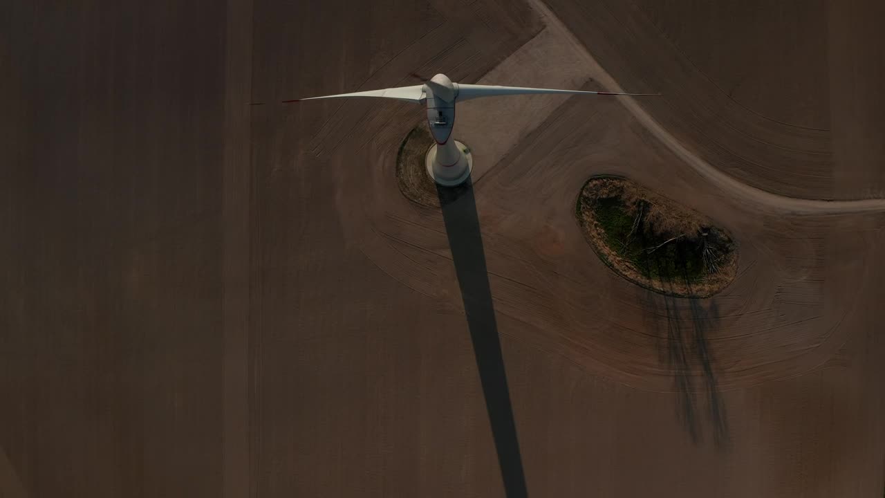 Free Video Stock top aerial shot of a wind turbine spinning Live Wallpaper