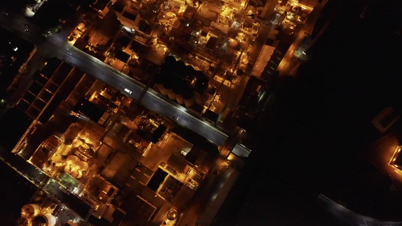 Free Video Stock top aerial view of a factory during night time Live Wallpaper