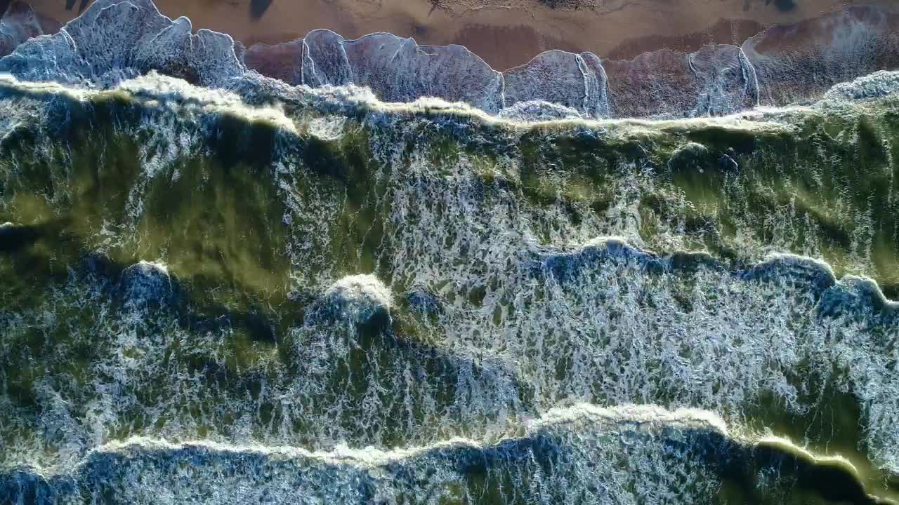 Free Video Stock top aerial view of the sea waves reaching a beach Live Wallpaper