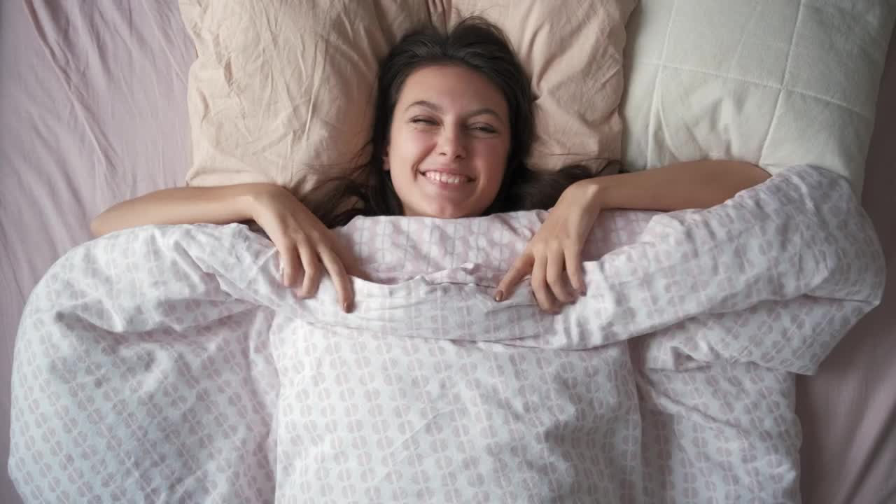 Free Video Stock top shot of a woman waking up in the morning Live Wallpaper