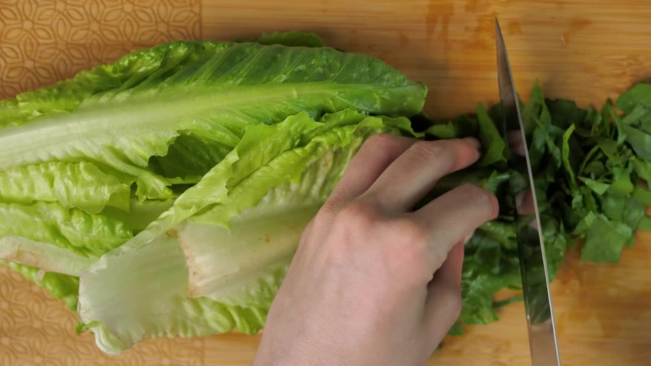 Free Video Stock top view of a person cutting lettuce Live Wallpaper