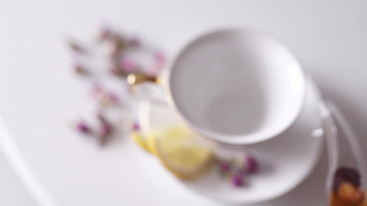 Free Video Stock top view of teapot pouring tea into china cup Live Wallpaper