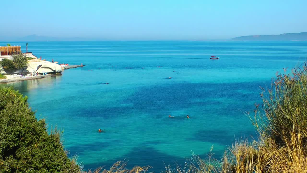 Free Video Stock tourist beach with clear water sea high view Live Wallpaper