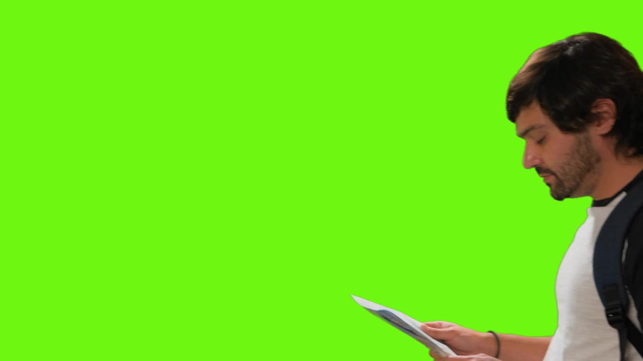 Free Video Stock tourist locating himself on a map on a chroma green Live Wallpaper