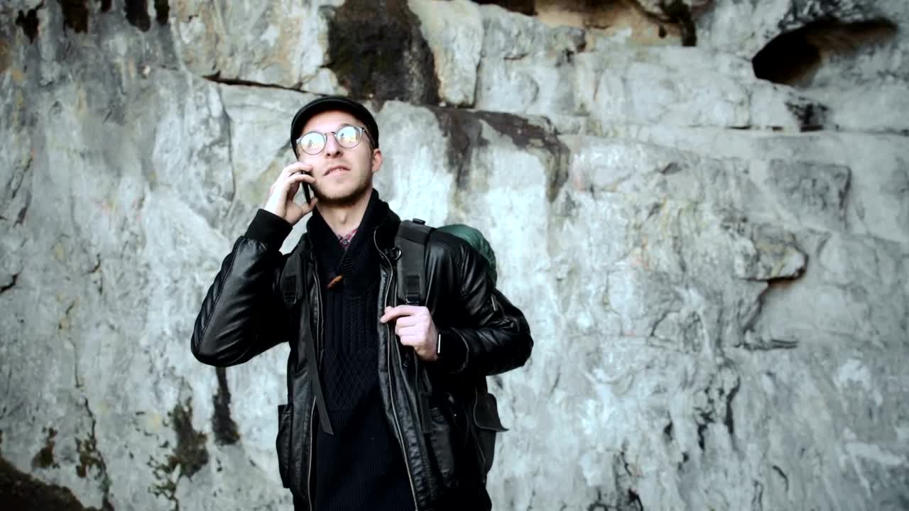 Free Video Stock tourist taking a call on a cave Live Wallpaper